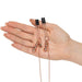 Hand holding Fifty Shades Freed All Sensation Nipple & Clitoral Chain