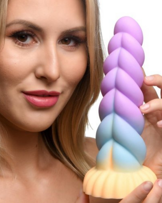 Mystique Thick 8 Inch Silicone Unicorn Dildo held by a female model on a white background