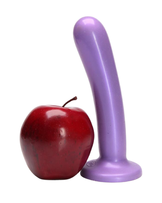 A red apple standing next to a purple Tantus Bend Over Intermediate 2 Dildos + Vibrating Strap-on Harness with a curved shape on a white background.