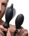 Dark Inflator Silicone Inflatable Anal Plug held by a man showing the plug and pump