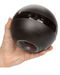 A person's hand holding a black, spherical CalExotics Masturball Rechargeable, Vibrating, Massaging Penis Masturbator with control buttons on top.
