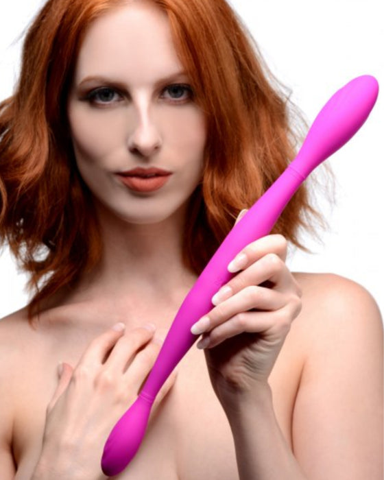 Double Thump 7X Rechargeable Silicone Double Dildo in the straight position held by a model