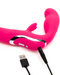 Happy Rabbit Strapless Strap On Rabbit Vibrator - Pink with charging cable plugged in