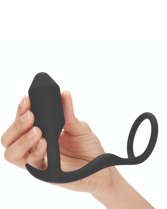 B-Vibe Snug and Tug model holding it in hand