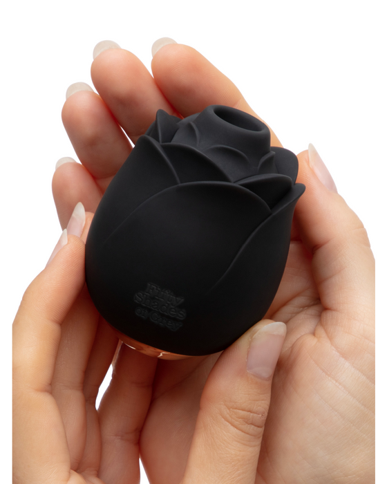 Model's hands holding Fifty Shades of Grey Hearts and Flowers Air Pulsation Black Rose Vibrator