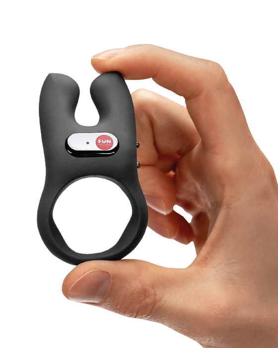 Fun Factory NŌS Vibrating Couples Penis Ring - Black held in a hand on a white background
