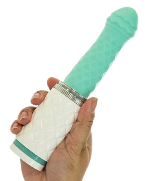 Pillow Talk Feisty Thrusting Vibrator - Teal on a white background held in a person's hand by the base