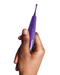 Zumio X Powerful Oscillating Rechargeable Clitoral Stimulator - Purple held in a woman's hand on a white background
