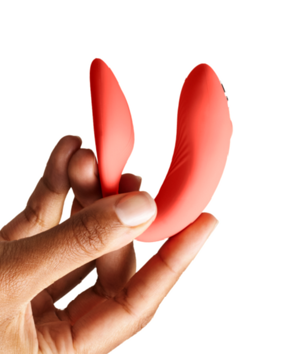 We-Vibe Chorus Remote & App Controlled Couples' Vibrator - Crave Coral held in a hand