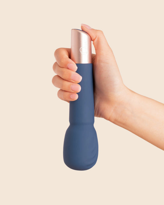Deia Textured Silicone Wand Vibrator held upside down in model's hand 