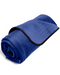 A neatly rolled-up royal blue Liberator Fascinator Throw Mini Sized Velvety Sex Blanket with dark edging, isolated on a white background.