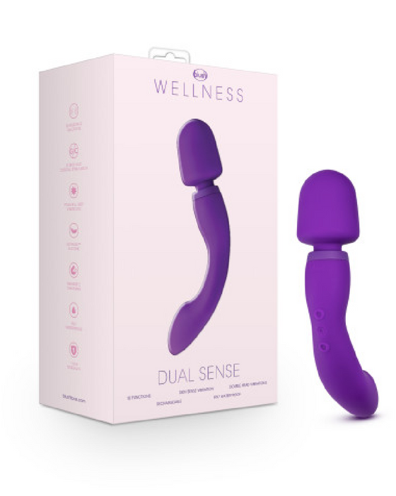 Product image of a purple "Wellness Dual Sense Double Ended Ergonomic Wand" wellness massager by Blush, displayed next to its packaging. The packaging is pink with icons and text detailing product features.