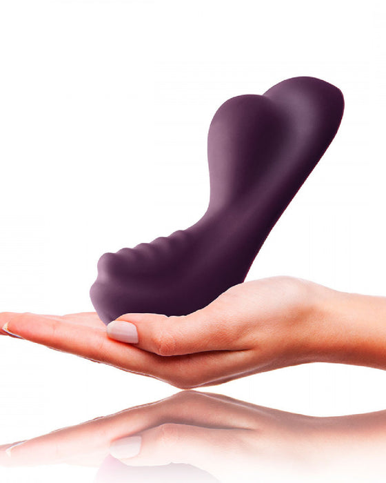 Ruby Glow Ride On External Hands-Free Vibrator held in a hand