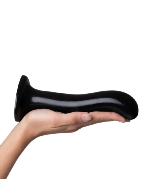 Strap-on-Me Large Prostate & G-Spot Dildo held horizontal in a person's palm with the tip facing down