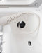 Close-up of a modern washing machine interior showing the detergent dispenser drawer, drum, and integrated Puritize Uvee Home Play Sex Toy Sanitizer & Charger - White from Clean Light Laboratories.