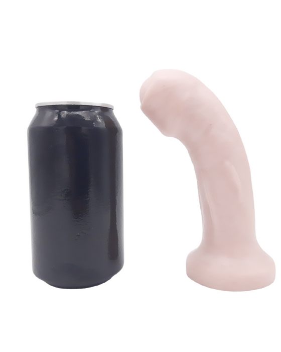 The Dulce Uncut Vanilla Tone Dual Density Silicone Dildo by Uberrime next to a pop can for scale