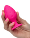 Cheeky Probe: 2 Graduated Textured Silicone Anal Plugs - Pink with larger plug held in a woman's hand against a white background