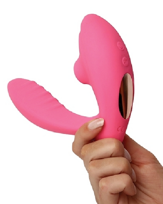 Beso Plus Suction Dual Stimulation Vibrator - Pink held in a person's hand to illustrate the size of the vibrator