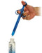 A hand holding a blue, phthalate-free dropper pipette, dispensing a liquid into a small bottle of XR Brands' One Shot XL Lubricant Applicator.