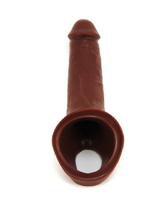 Vixen Ride On 6.25 Inch Silicone Penis Extension - Chocolate looking down into the ball strap and entrance on a white background