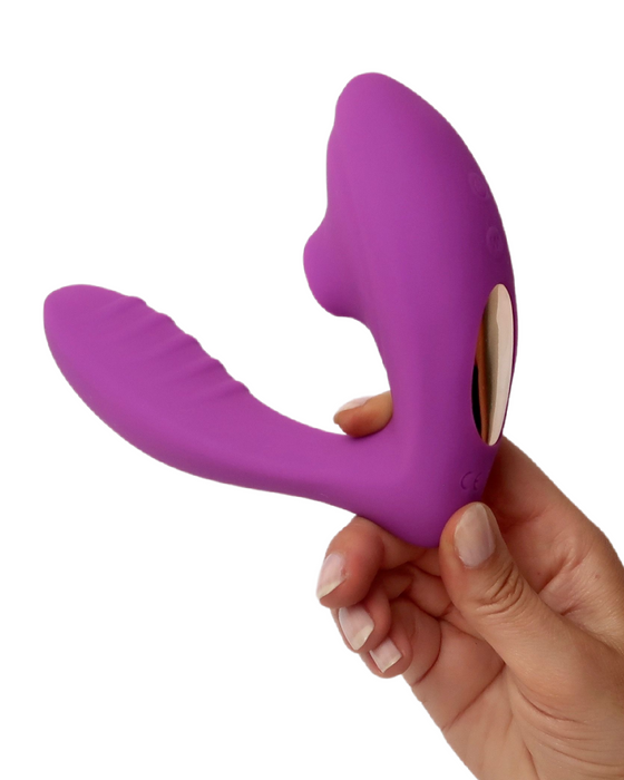 Beso Plus Suction Dual Stimulation Vibrator - Purple held in a person's hand to illustrate the size of the vibrator