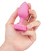 B-vibe Vibrating Heart Shaped Jewel Anal Plug S/M - Pink in model's hand 