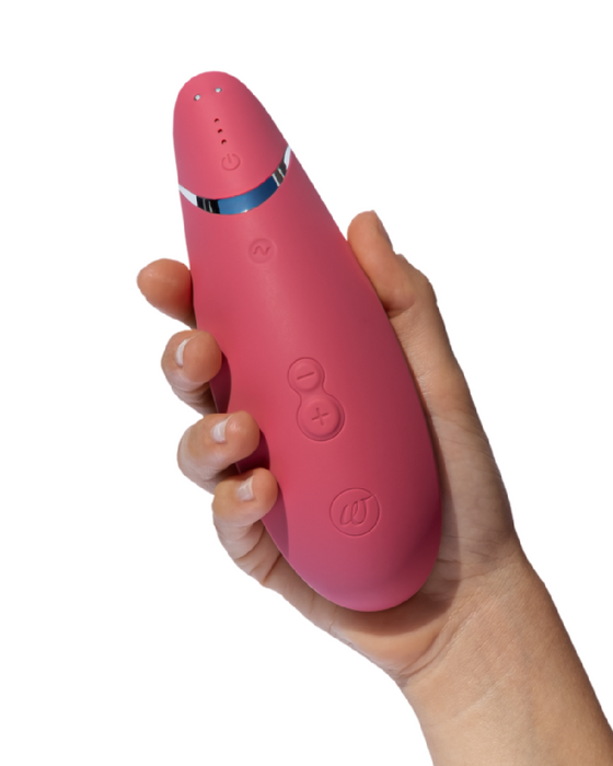 Womanizer Premium 2 Pleasure Air Clitoral Stimulator - Raspberry in model's hand