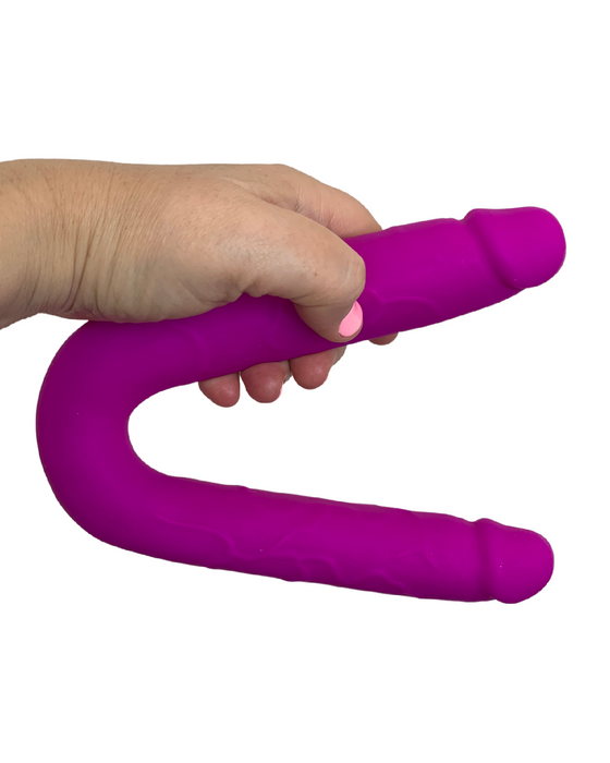 Colours Double Penetration U Shaped Dildo - Purple held in a hand on a white background