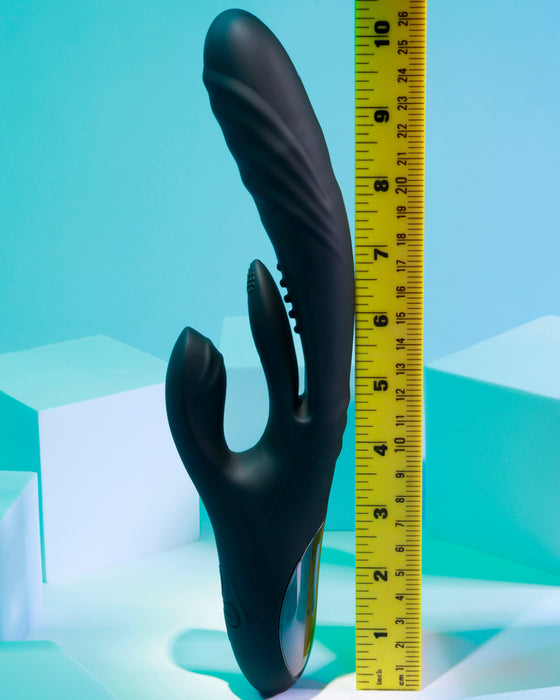 Measuring the size of a Playboy Rapid Rabbit Thrusting Vibrator with Flapping Shaft from Evolved Novelties against a tape measure for precise dimensions.