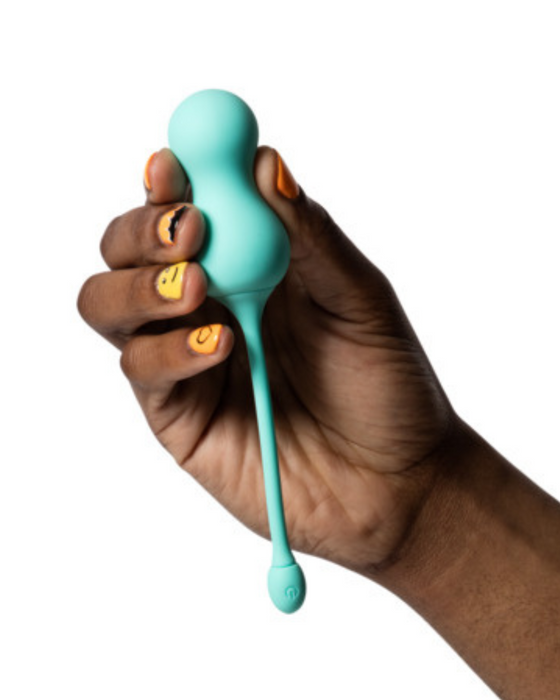 Romp Cello Remote Control G-spot Vibrating Egg being held by a hand on a white background