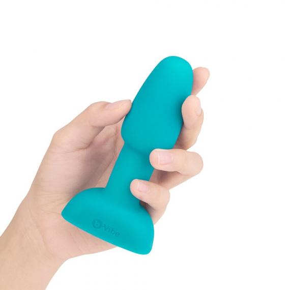 Hand holding B-Vibe Silicone Rechargeable Rimming Butt Plug Petite  teal