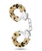 Temptasia Furry Cuffs Handcuffs with a leopard print design, perfect for role play, hanging in the air against a white background.