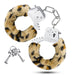 A pair of Temptasia Furry Cuffs Handcuffs with leopard print faux fur for role play, alongside a set of keys. (Blush)