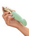Fun Factory Sundaze Thrusting Vibrator - Pistachio held in a person's hand against a white  background to show the size